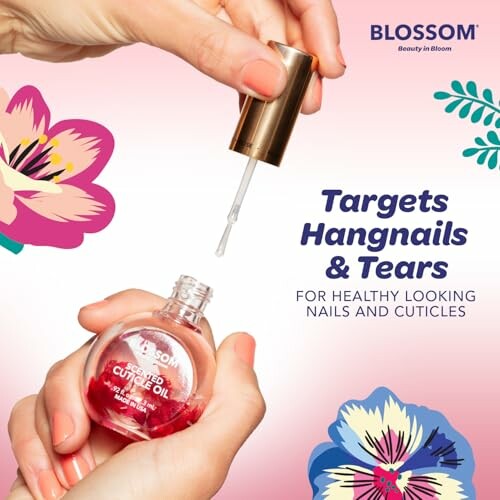 Hands applying Blossom cuticle oil with floral design.