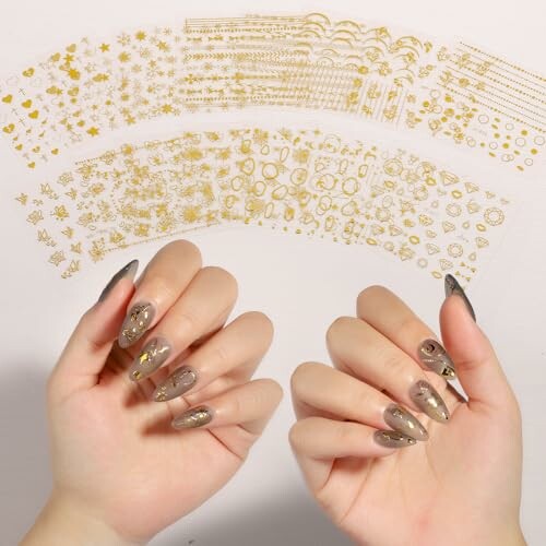 Hands with decorated nails and various gold nail art stickers.