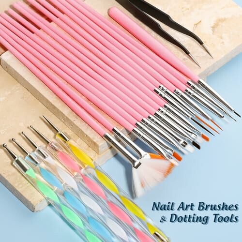 Set of nail art brushes and dotting tools on a tiled surface.