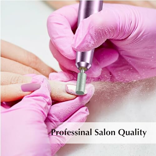 Close-up of professional manicure with pink gloves and nail drill.